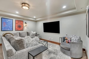 Relaxing den area with entertainment center featuring a 75 flat screen TV