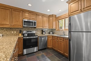 The kitchen offers wood cabinets and stainless steel appliances.