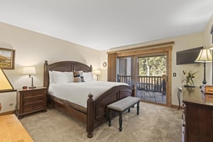 The main suite offers a king size bed and sliding glass doors to a private patio.