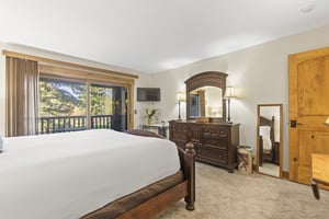 The main suite offers a king size bed and sliding glass doors to a private patio.