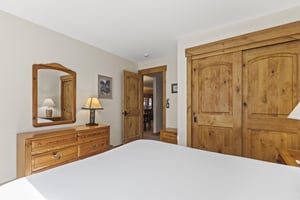 The bedroom offers a queen size bed and well appointed furniture.