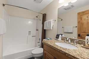 The shared bathroom has a bathtub and shower combination.