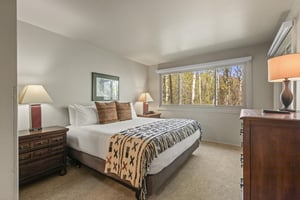 The main suite has a king size bed and large window overlooking the aspen grove.
