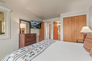 The main suite has a king size bed and wall mounted flat screen TV.