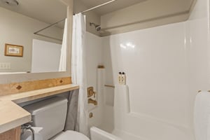 The shared bathroom has a bathtub and shower combination.
