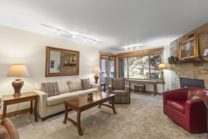 The living area with a comfortable couch and club chairs.