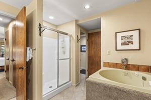 The en suite bathroom has a walkin shower and deep soaker bathtub.