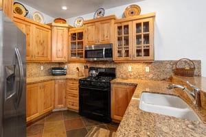The wellequipped kitchen offers solid wood cabinets, granite counters and spacious floor plan.