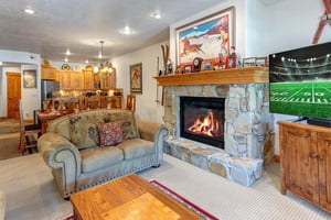 Town Pointe C302 has a cozy living room with fireplace and flat screen TV.