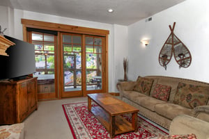 Town Pointe C302 has a cozy living room with access to a private deck and hot tub.