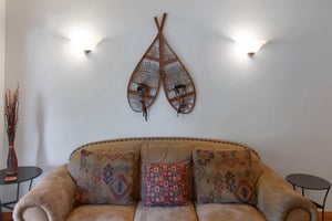 Town Pointe C302 has cozy leather furnishings and wooden snowshoes mounted on the wall.