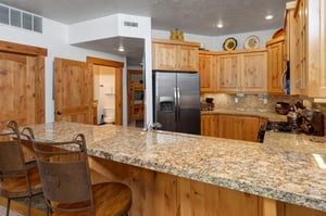 The wellequipped kitchen offers a breakfast bar with seating for 2.
