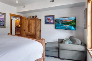The main suite offers a king size bed, comfortable sitting area, and flat screen TV.