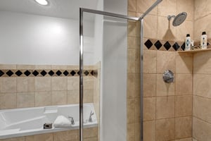 The en suite bathroom offers a deep soaker bathtub and walkin shower.