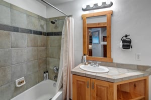 The shared bathroom with bathtub and shower combination.
