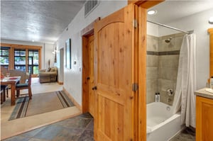 The shared bathroom with bathtub and shower combination.