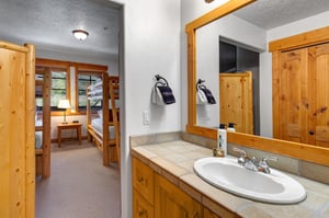 The en suite bathroom has a single sink vanity.