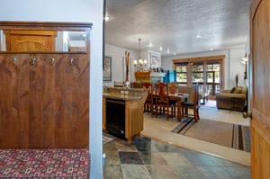 The entryway with a place to sit to remove shoes and hang a coat.