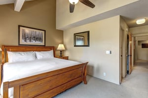 The main suite has a king size bed and well appointed wood furniture.