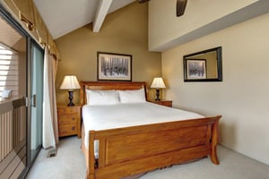 The main suite has a king size bed and well appointed wood furniture.