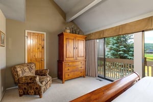 The main suite has a king size bed and well appointed wood furniture.