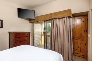 The second bedroom has a queen size bed and TV.