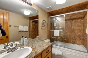 The shared bathroom has a bathtub and shower combination.