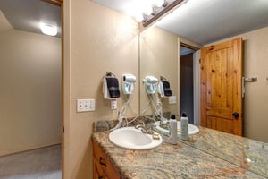 The bathroom has a two sink vanity.