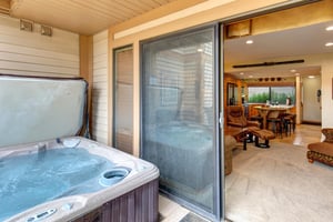 The hot tub located just outside the living room on the private patio.
