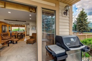 A BBQ gas grill located just outside the living room on the private patio.