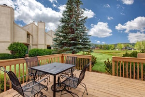 The  outdoor dining area on the private outdoor deck overlooking the golf greens and lake.