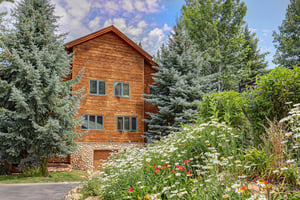 Timber Wolf Lodge with wild flowers in the summer.
