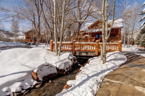 A bridge crossing the small stream at Timber Wolf with snow on the ground.
