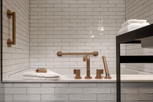 The en suite bathroom done in black, white and gold and deep soaker tub.