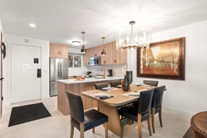 The dining table offers seating for 6 guests and has a gorgeous modern chandelier.