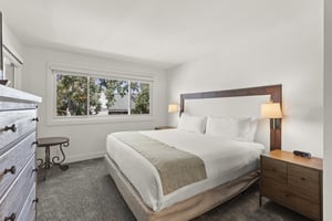 The main suite bathroom has a king size bed and large window.