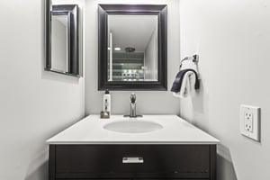 The shared bathroom with a single sink vanity.