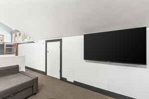The loft has a wall mounted flat screen TV.