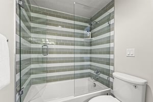 The loft has an en suite bathroom with a bathtub and shower combination.