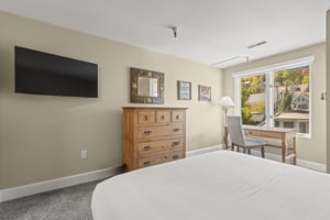 The main suite with a queen size bed and wellappointed furniture.