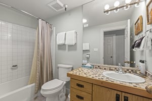 The bathroom with a bathtub and shower combination.