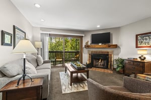 The living room opens up to a private patio overlooking the aspens.