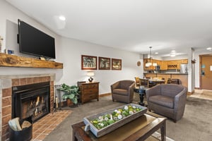 The living room with wood furniture and two upholstered club chairs.