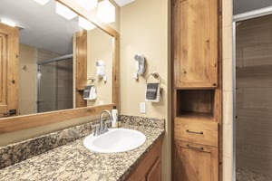 The en suite bathroom has a single sink vanity.