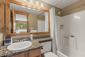 The shared bathroom has a bathtub and shower combination.