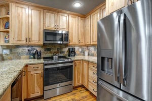 The kitchen offers stainless steel appliances and granite counters.