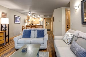 The loveseat and couch is a light cream color with accent pillows.