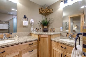 The spacious shared bathroom with 2 sink vanity.