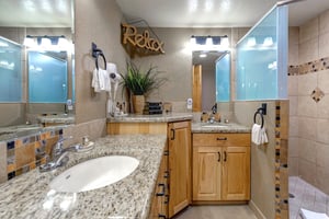 The spacious shared bathroom with 2 sink vanity.
