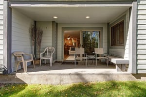 The private patio with 4 chairs and a bench.
